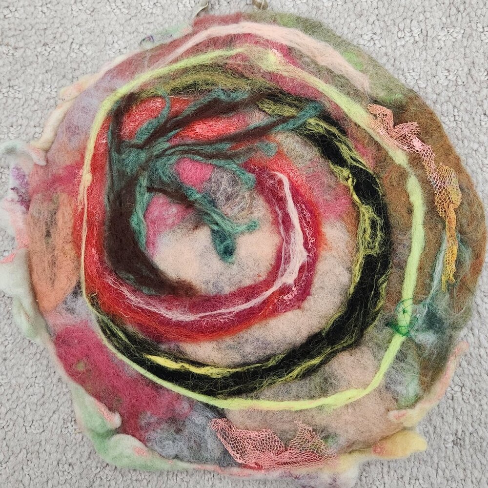 New handmade felted with fine wool and fibers. 9 inch diameter ready to hang.